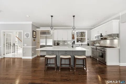 a large kitchen with a table and chairs