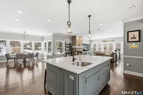 a kitchen with center island table and chairs