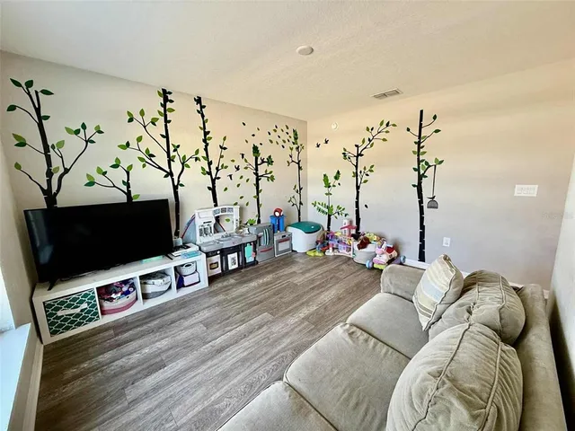 a bedroom with a bed and a potted plant