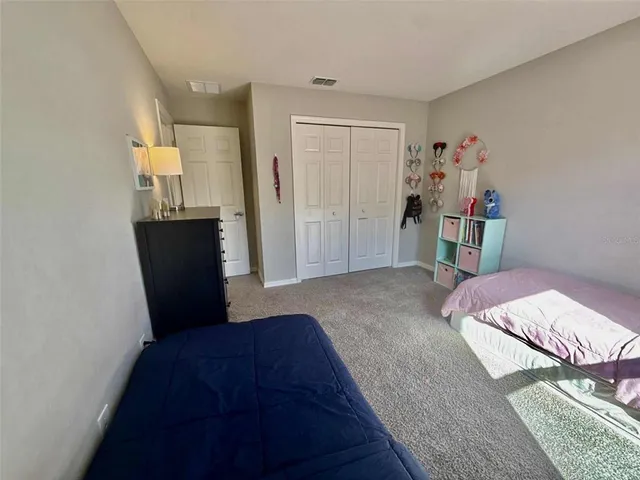 a bedroom with a bed a table and a window