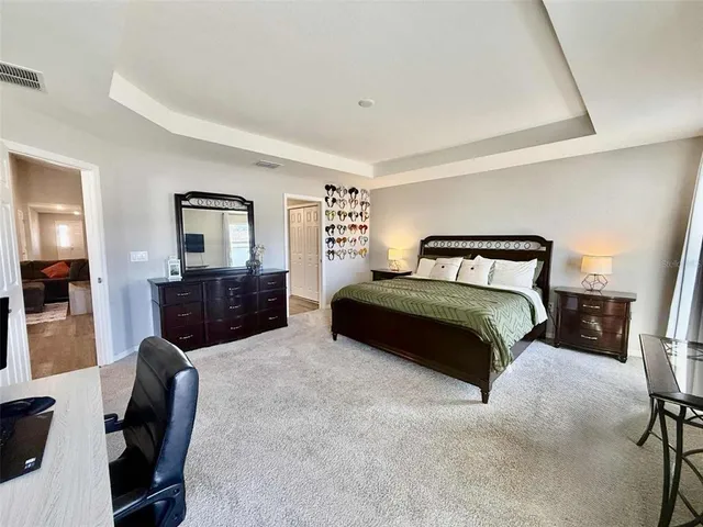 a bedroom with a bed couch and a window