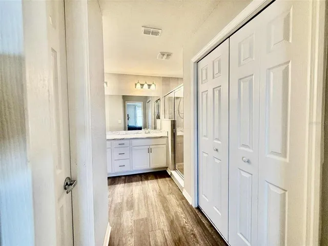 a bathroom with a double vanity sink a mirror and a toilet