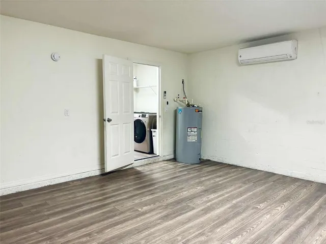 a view of a room with wooden floor and cabinet