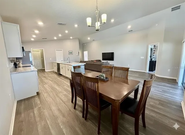 a view of a dining room with furniture and wooden floor