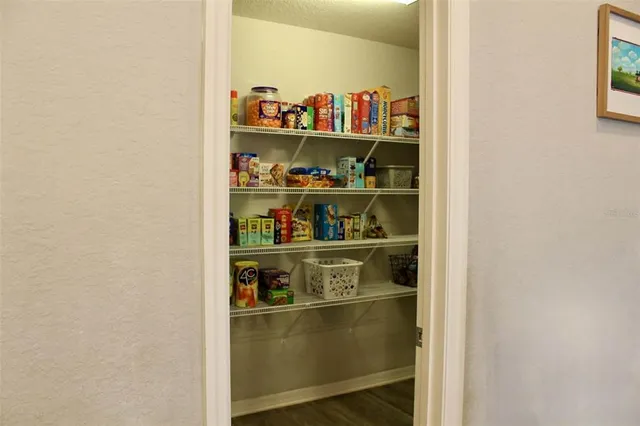 a shelf with cup and plates