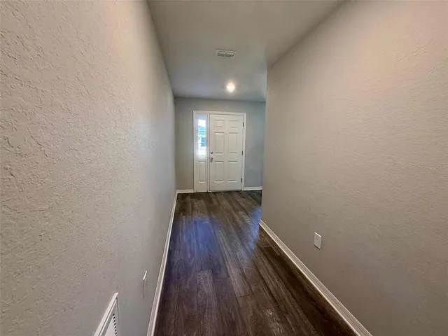 a bathroom with a granite countertop toilet a sink and a mirror