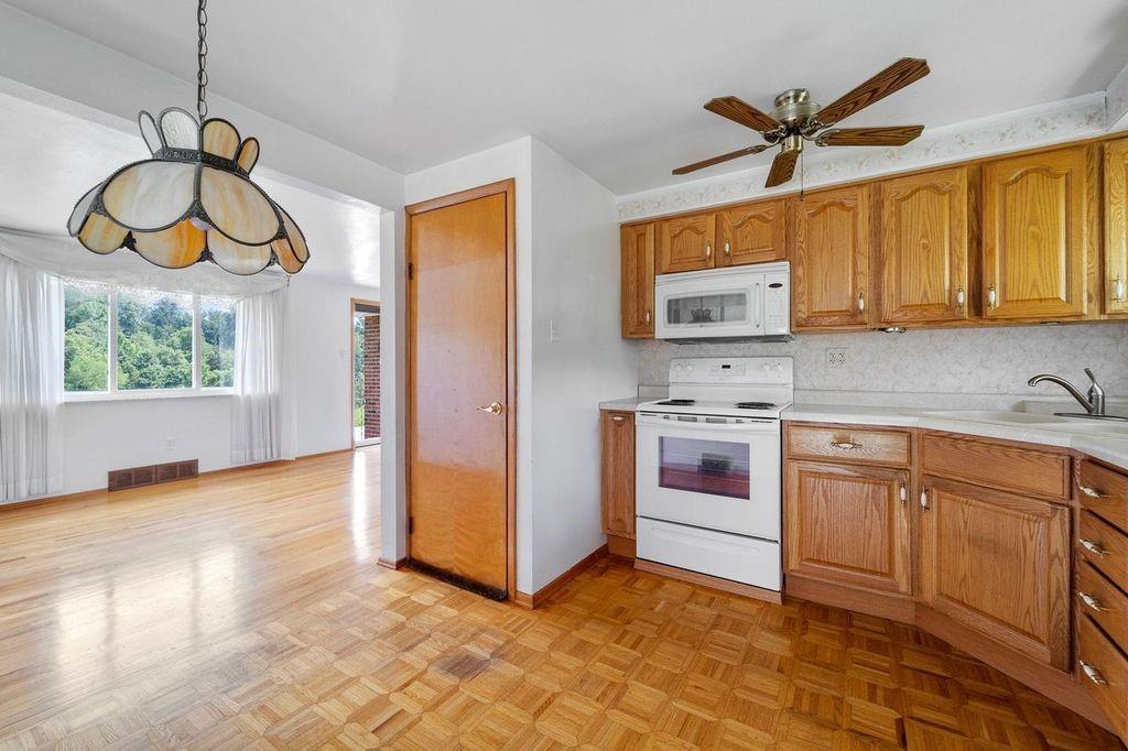 506 Vaneal Road Washington, PA 15301 - Photo 8 of 25 a kitchen with stainless steel appliances granite countertop a stove a sink and a microwave