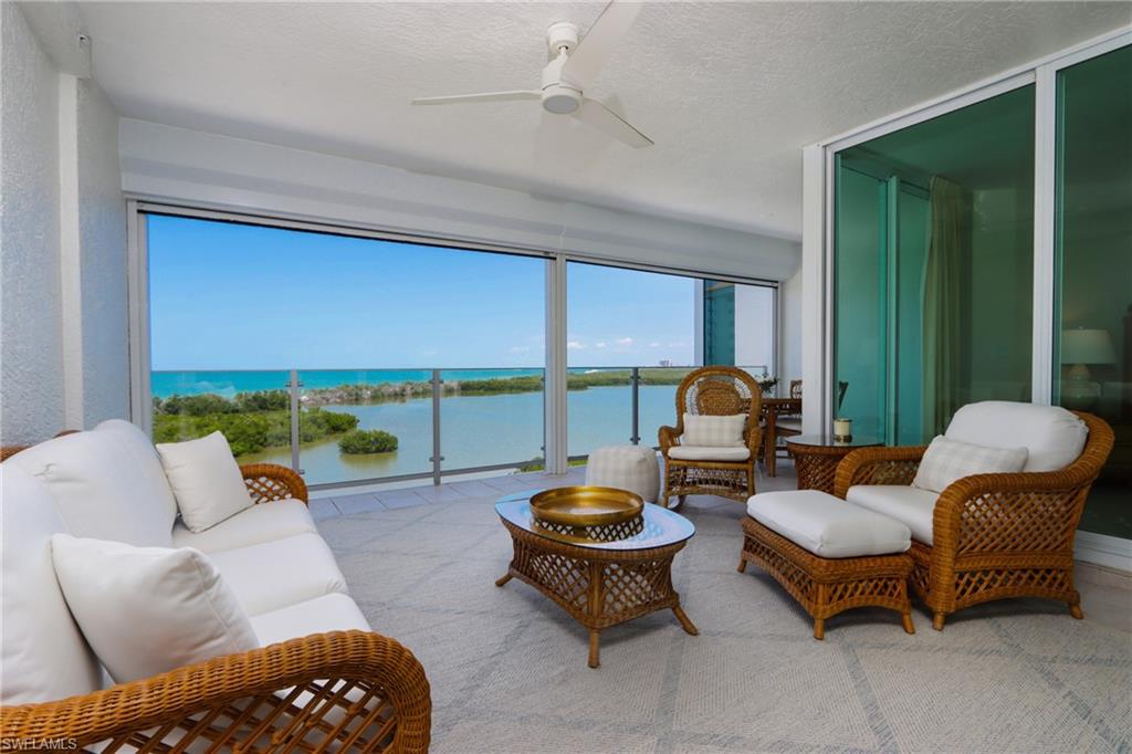 60 Seagate Drive, Unit 704 Naples, FL 34103 - Photo 2 of 28 a living room with furniture and a large window