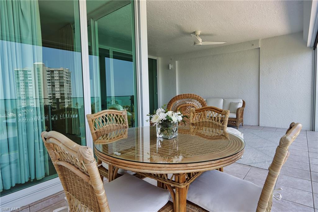 60 Seagate Drive, Unit 704 Naples, FL 34103 - Photo 4 of 28 a dining room with furniture and window