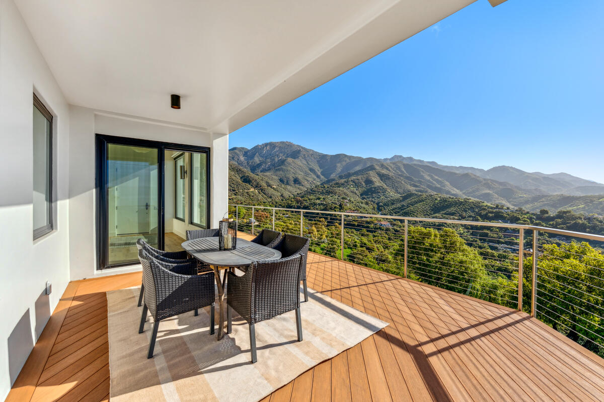 2870 Holly Road Santa Barbara, CA 93105 - Photo 22 of 39 a view of a balcony with a table and chairs