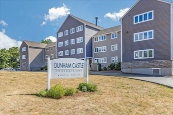 38 Dunham Road, Unit 109 Beverly, MA 01915 - Photo 1 of 24 a sign on the side of a building