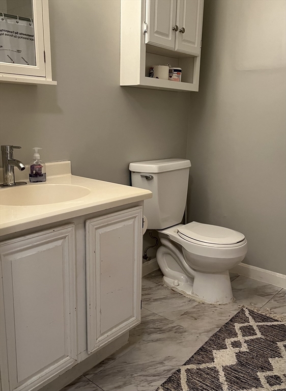 38 Dunham Road, Unit 109 Beverly, MA 01915 - Photo 13 of 24 a bathroom with a toilet and a sink