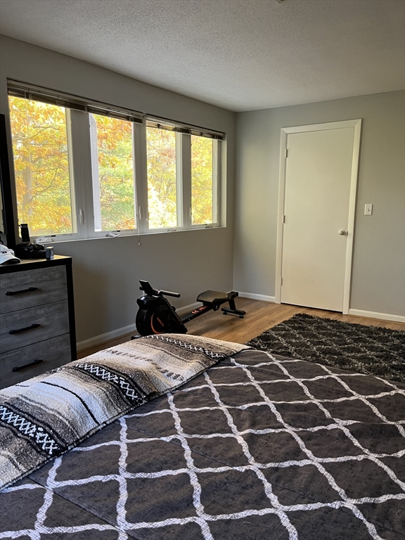 38 Dunham Road, Unit 109 Beverly, MA 01915 - Photo 17 of 24 a bedroom with a bed and a window