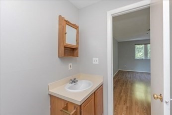 38 Dunham Road, Unit 109 Beverly, MA 01915 - Photo 19 of 24 a bathroom with a sink a mirror and vanity