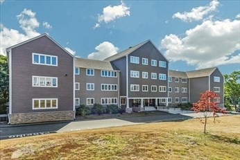 38 Dunham Road, Unit 109 Beverly, MA 01915 - Photo 2 of 24 a view of a building with a swimming pool