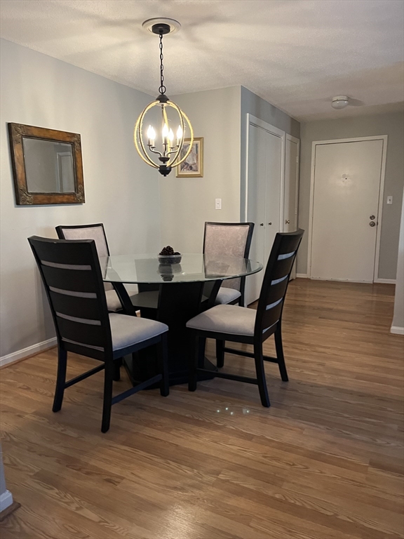 38 Dunham Road, Unit 109 Beverly, MA 01915 - Photo 7 of 24 a view of a dining room with furniture and wooden floor
