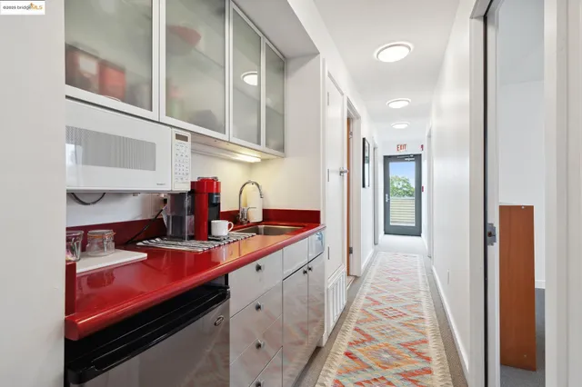 a kitchen with kitchen island a sink stove and cabinets