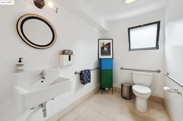 a white toilet sitting next to a bathroom sink