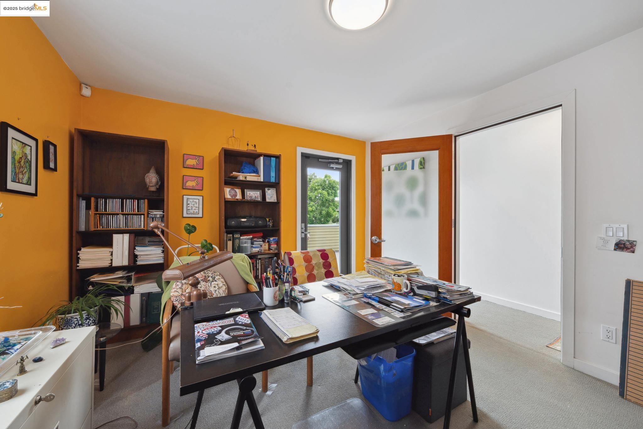 1010 Grayson Street Berkeley, CA 94710 - Photo 16 of 35 a view of a workspace with furniture and a bookshelf