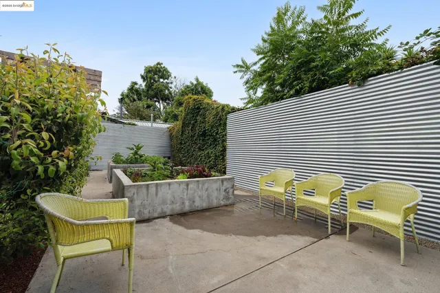 a view of patio with a chairs and potted plants