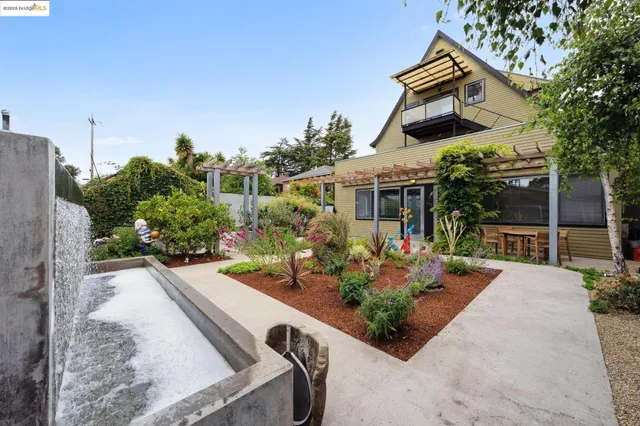 front view of house with a yard and potted plants