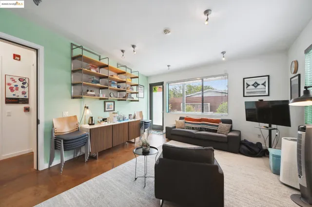 a bedroom with furniture and a flat screen tv