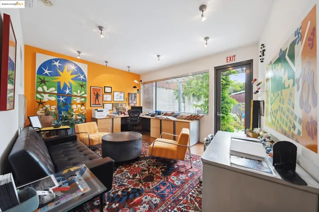 a living room with fireplace furniture and a large window