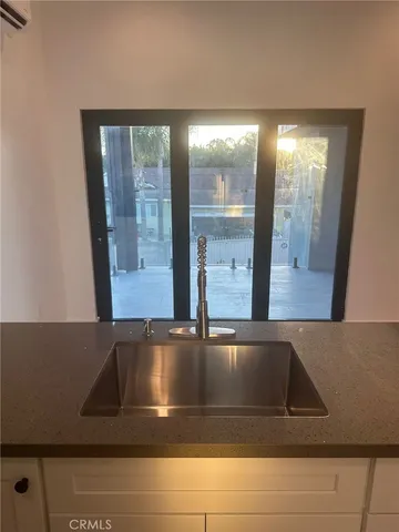 a kitchen with a refrigerator and a sink