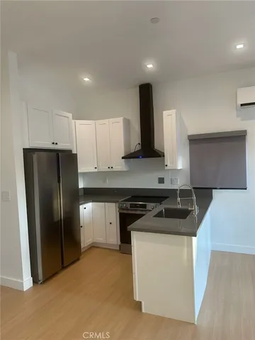 a kitchen with a refrigerator and a sink
