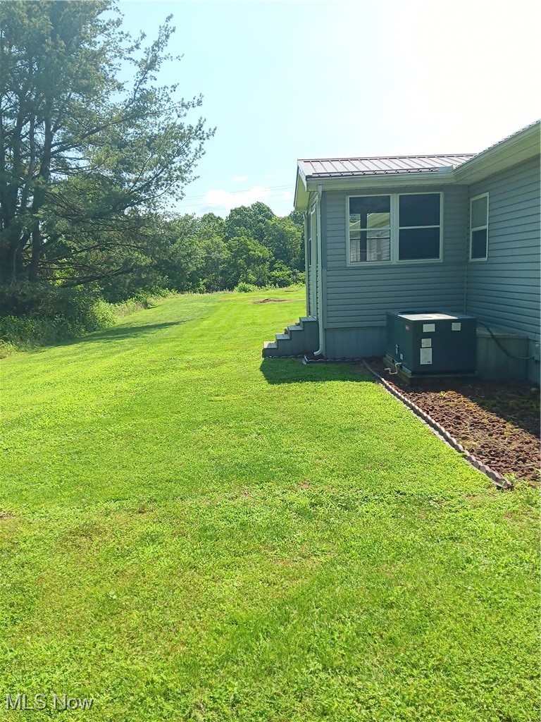 76241 Old Twenty One Road Kimbolton, OH 43749 - Photo 29 of 36 View of grassy yard and rear of the home