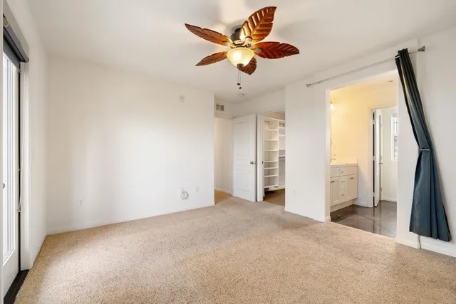 an empty room with cabinet and a ceiling fan