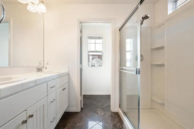 a bathroom with a double vanity sink and mirror