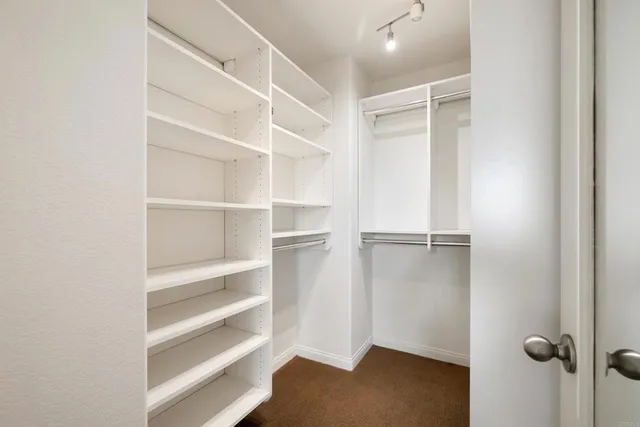a view of walk in closet with empty racks
