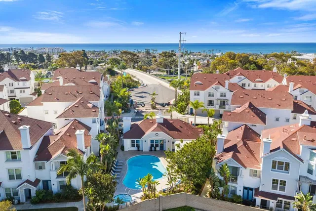 an aerial view of residential houses with outdoor space