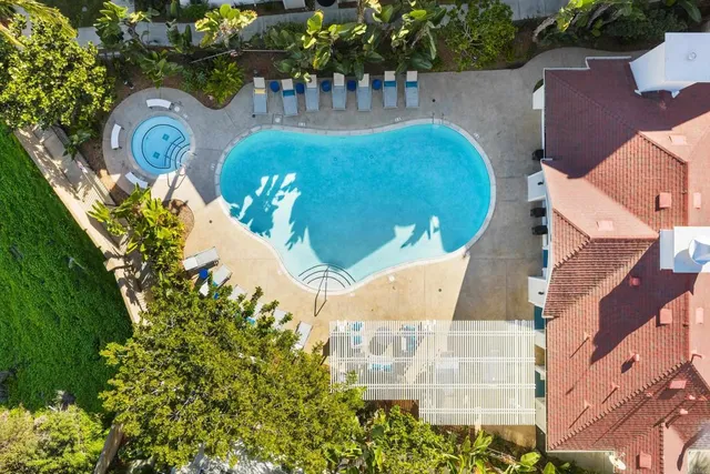 an aerial view of a house with swimming pool and outdoor space