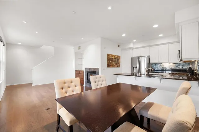 a large kitchen with kitchen island a dining table and chairs