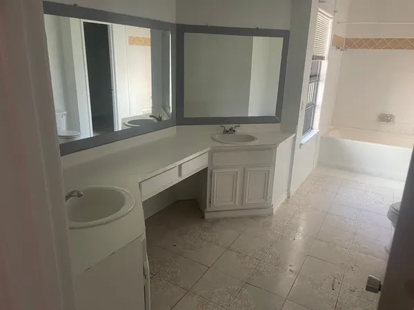 a bathroom with a bathtub sink and mirror