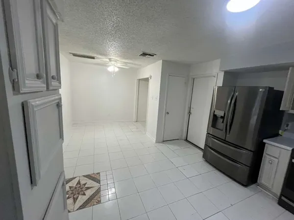 a view of a refrigerator in kitchen