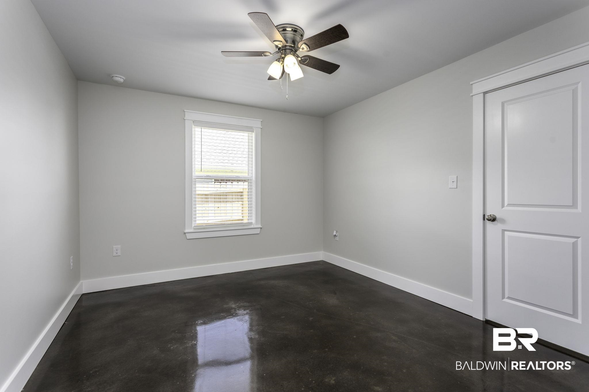 17126 Sugar Loop Foley, AL 36535 - Photo 18 of 28 Empty room featuring concrete floors, ceiling fan, and a smoke detector