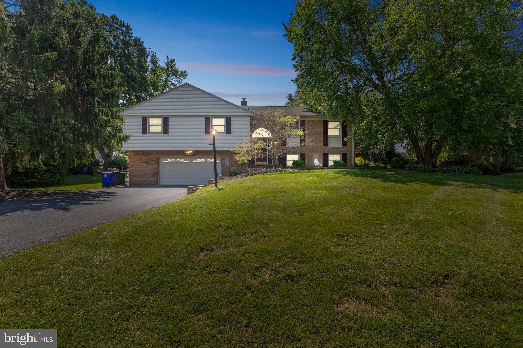 4008 Briars Road Olney, MD 20832 - Photo 2 of 32 a front view of a house with a garden