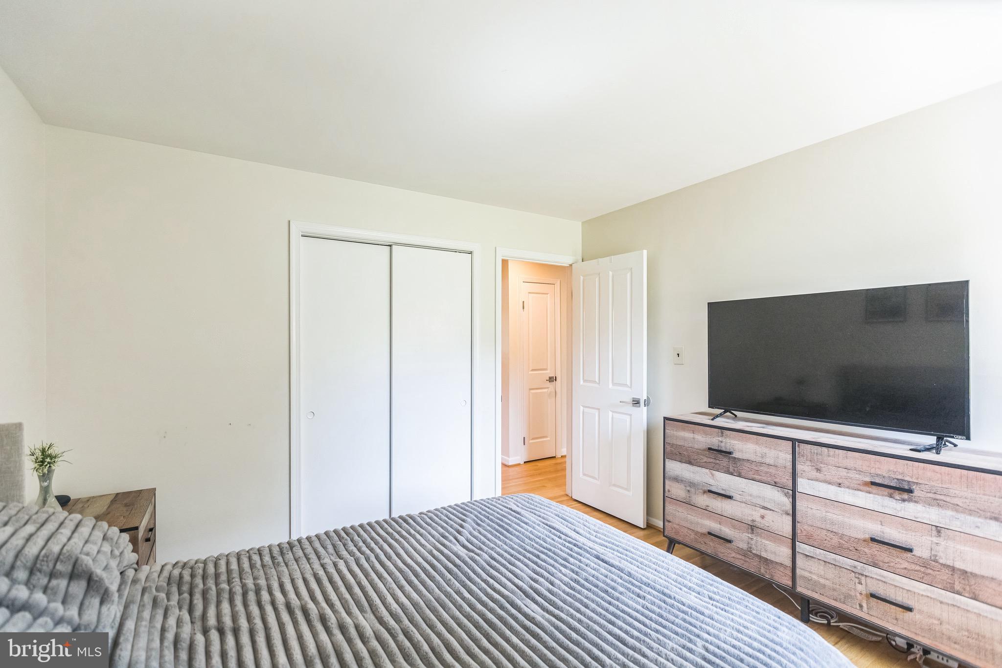 4008 Briars Road Olney, MD 20832 - Photo 21 of 32 a bedroom with a bed and a flat screen tv