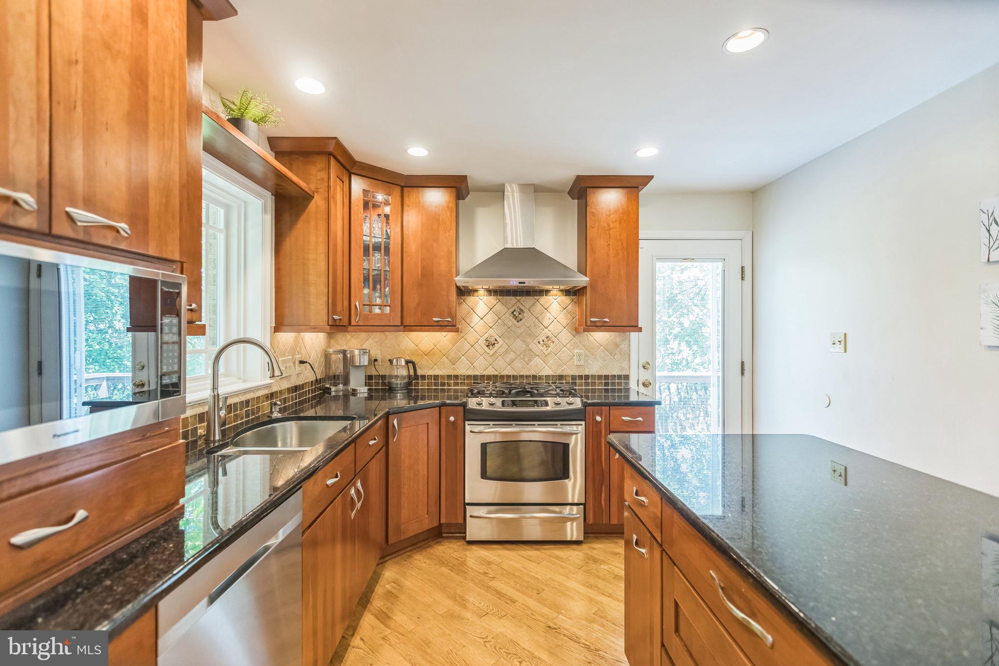 4008 Briars Road Olney, MD 20832 - Photo 3 of 32 a kitchen with stainless steel appliances granite countertop a sink stove and refrigerator