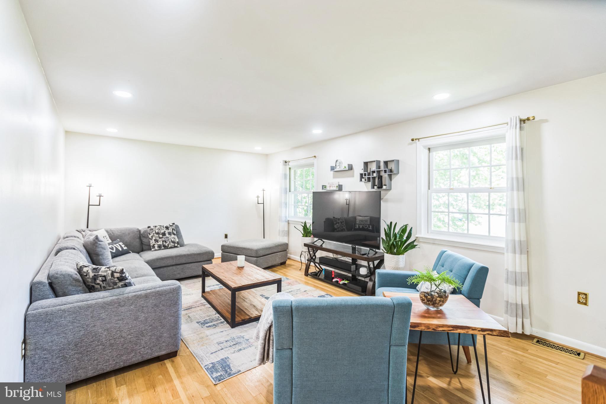 4008 Briars Road Olney, MD 20832 - Photo 10 of 32 a living room with furniture and a flat screen tv
