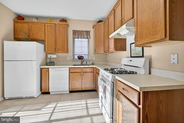 a kitchen with a sink stove and refrigerator