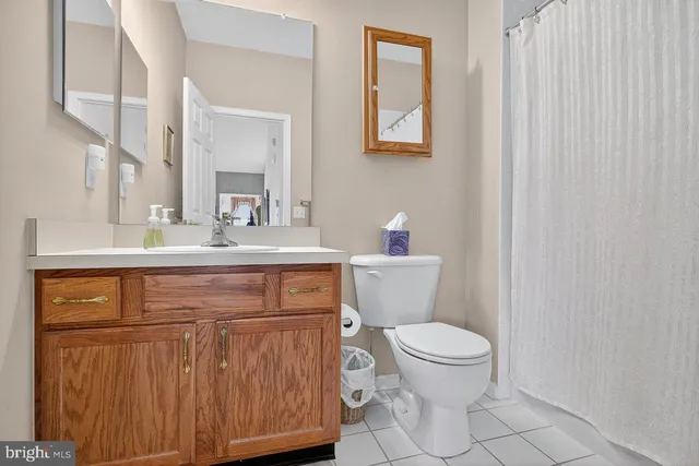 a bathroom with a toilet a sink and a mirror