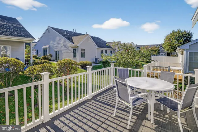 a view of a house with a chairs and table in the balcony