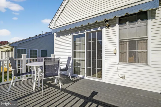 a view of a patio with table and chairs and wooden floor