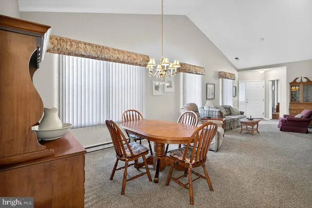 a dining room with furniture and window