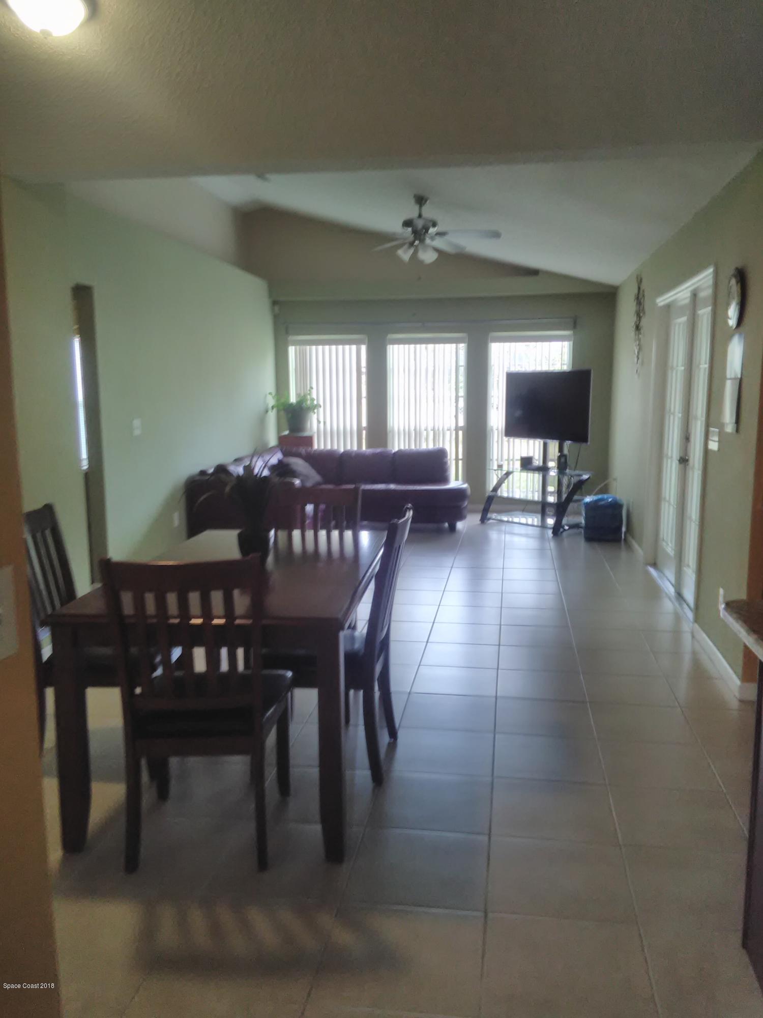 231 Rheine Road Northwest Palm Bay, FL 32907 - Photo 6 of 10 a view of a dining room with furniture