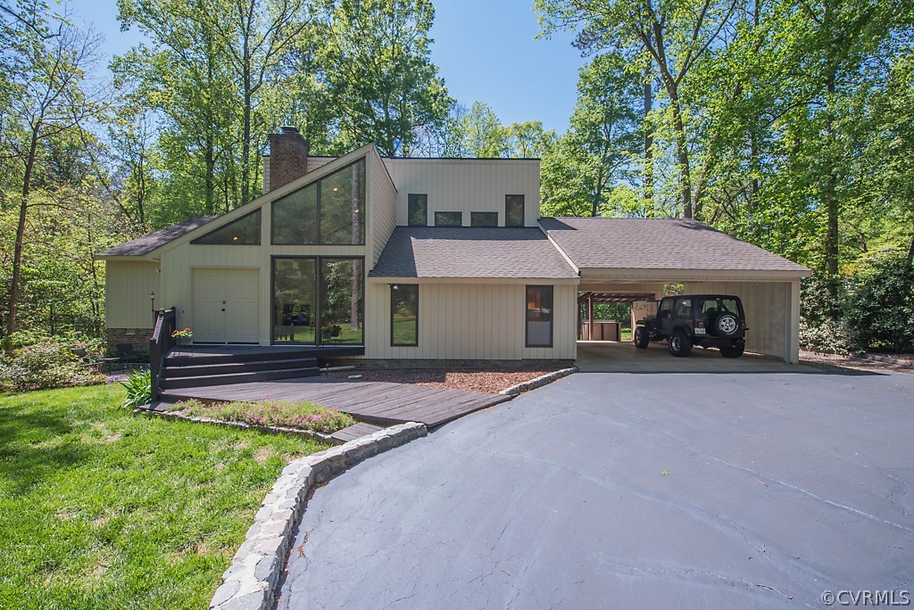 a front view of a house with a garden and yard